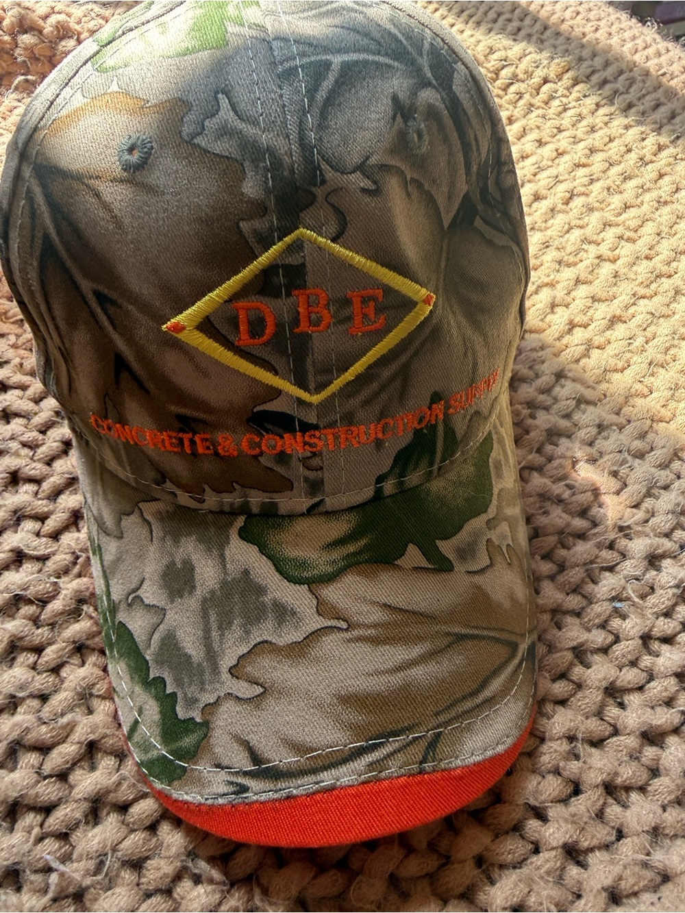 Camo 100% hat with orange accents
